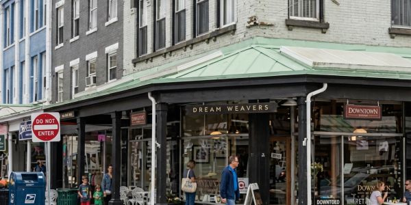 Visitors exploring a stone ruin and cultural landmark surrounded by greenery in the Catskills.