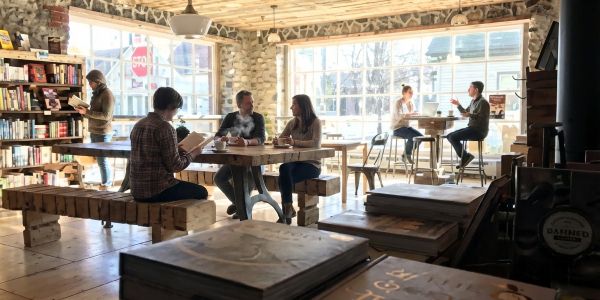 Friends and families enjoying brunch at a cozy Catskills restaurant with wood interiors and natural light.