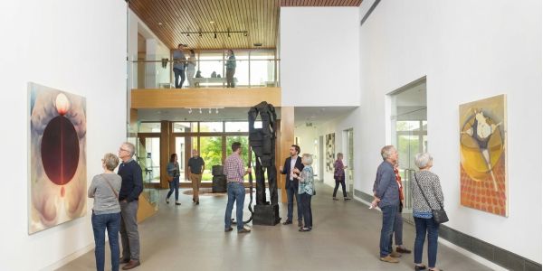 Visitors exploring a stone ruin and cultural landmark surrounded by greenery in the Catskills.