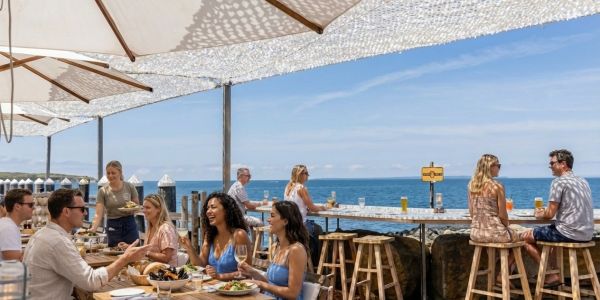 Large wheels and slices of artisan cheese displayed on a wooden counter at a Vermont market