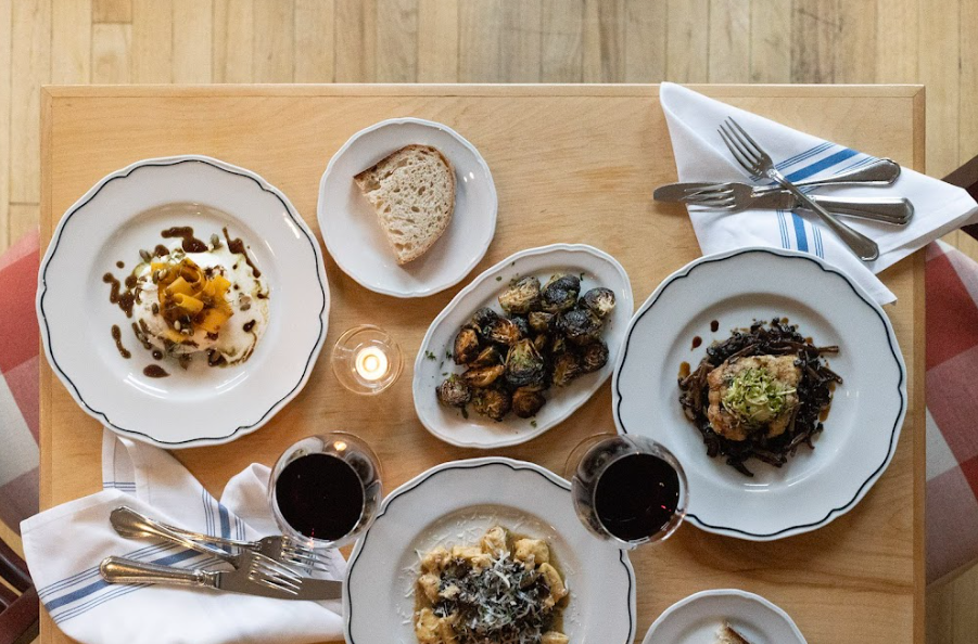 Table with pasta dishes bread and wine 