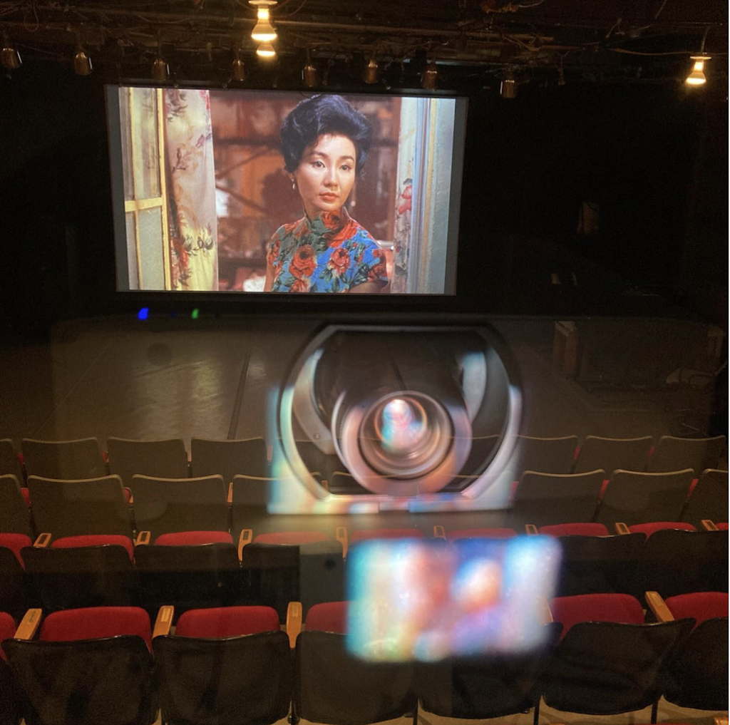 Inside the movie theater with a vintage movie playing 