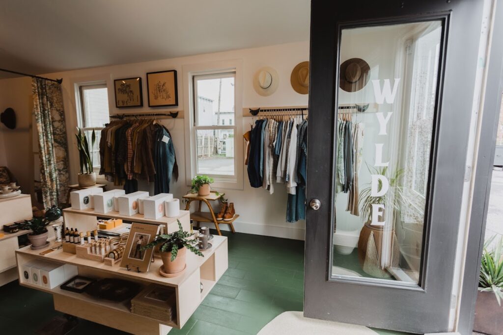 Inside store showing display of goods and clothing rack