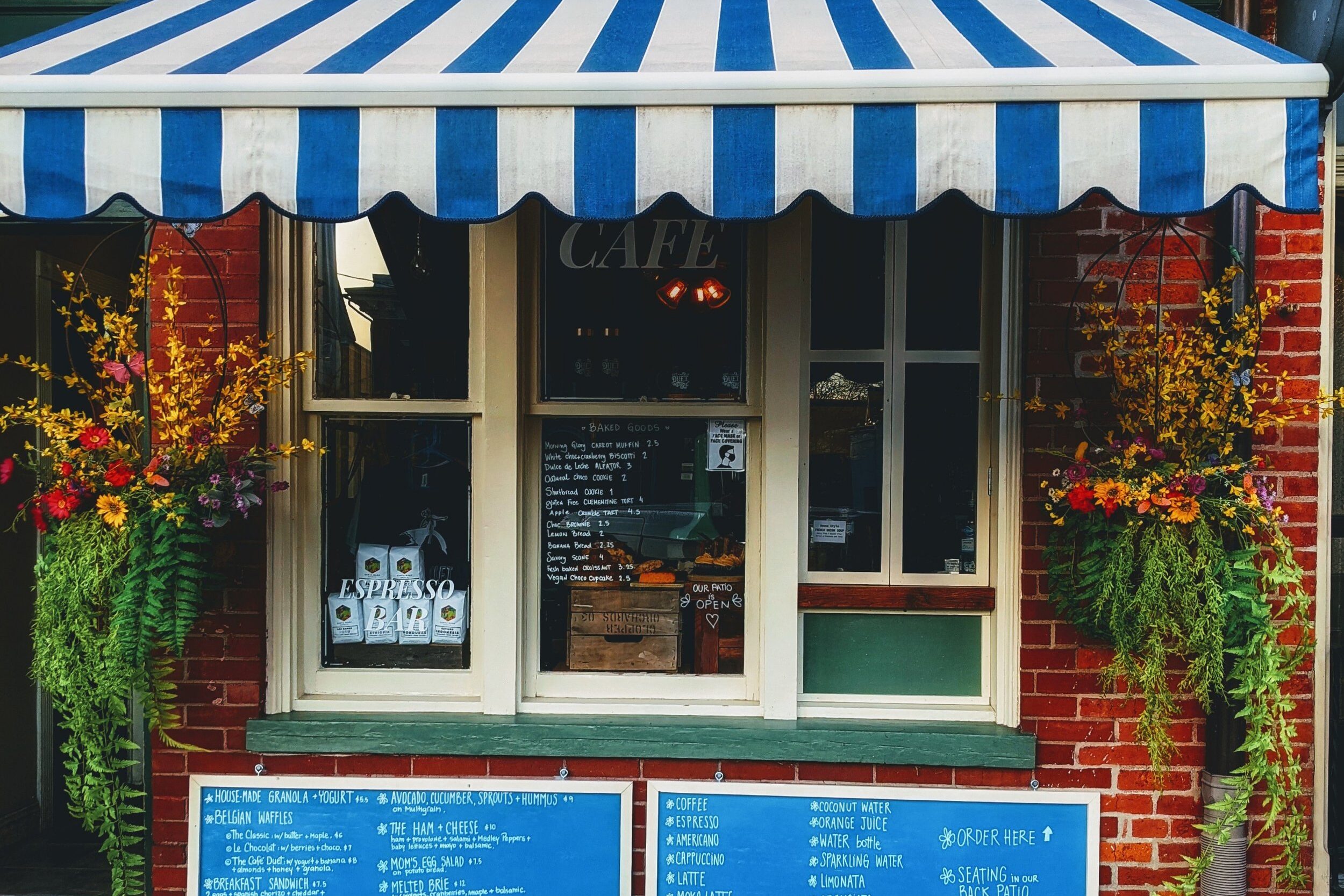 Outside picture of the cafe and it's chalk board menus 