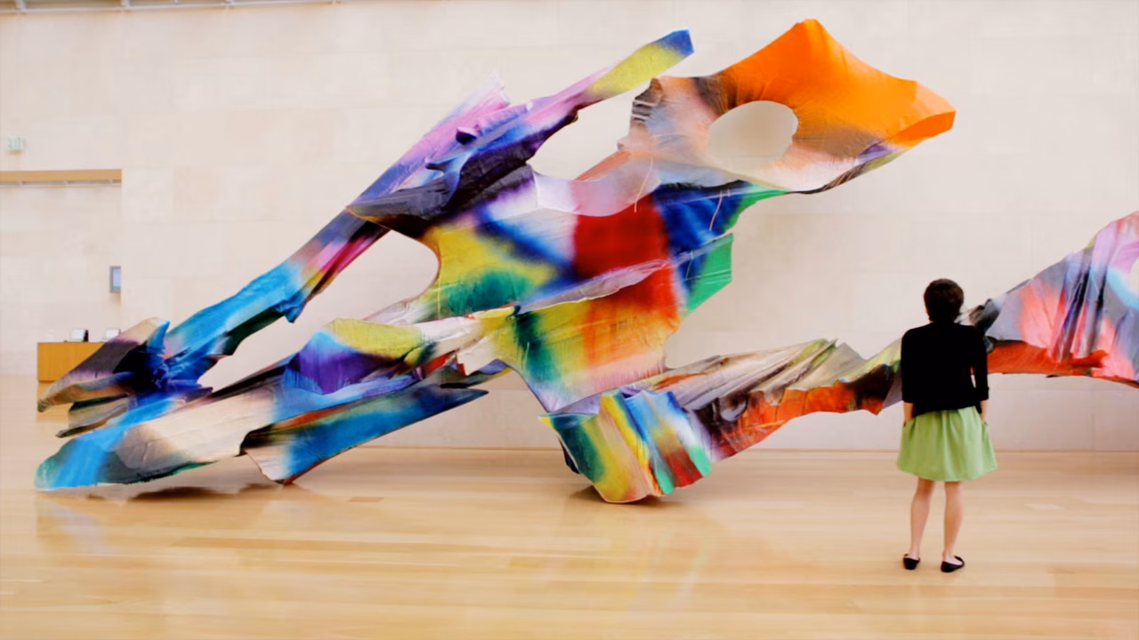 Girl standing in front of art work